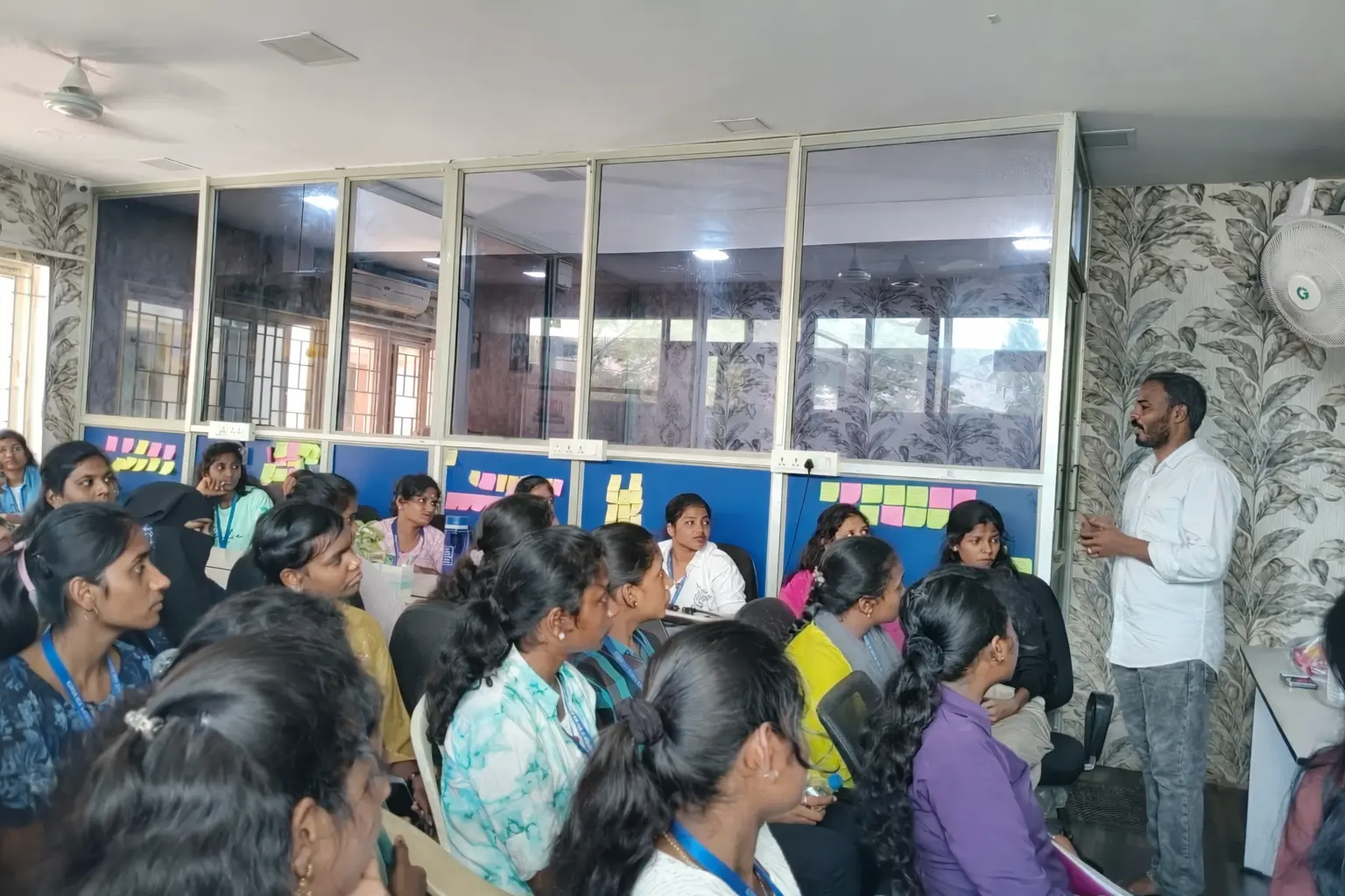 Women in traditional attire listening attentively.webp